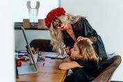 A woman in Halloween makeup applies face paint to a child in Erfurt, Germany.